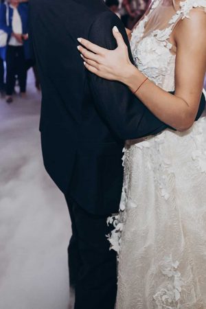 first wedding dance of bride and groom. wedding couple dancing at luxury reception. dress close up. hugging and swaying. beautiful newlyweds. space for text
